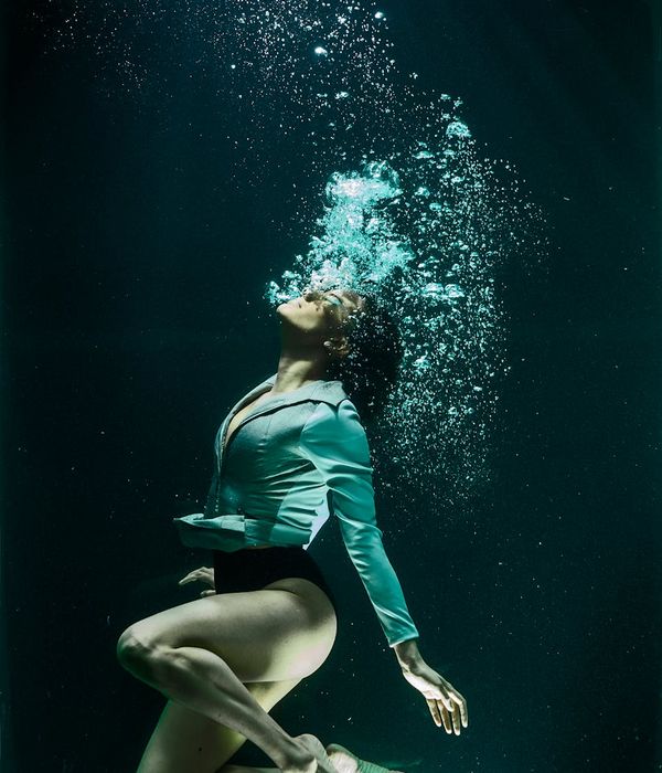 Person in a dynamic yet graceful pose, suggesting fluid motion.