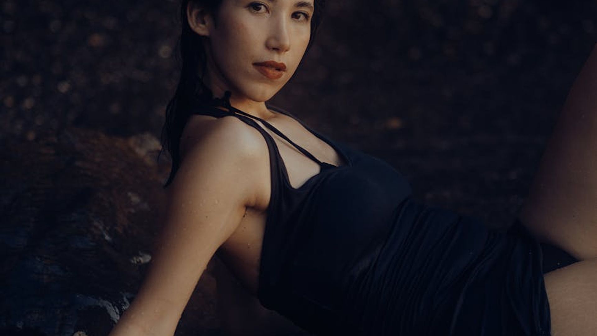 Woman silhouette in a calm cardio pose against a dark background.